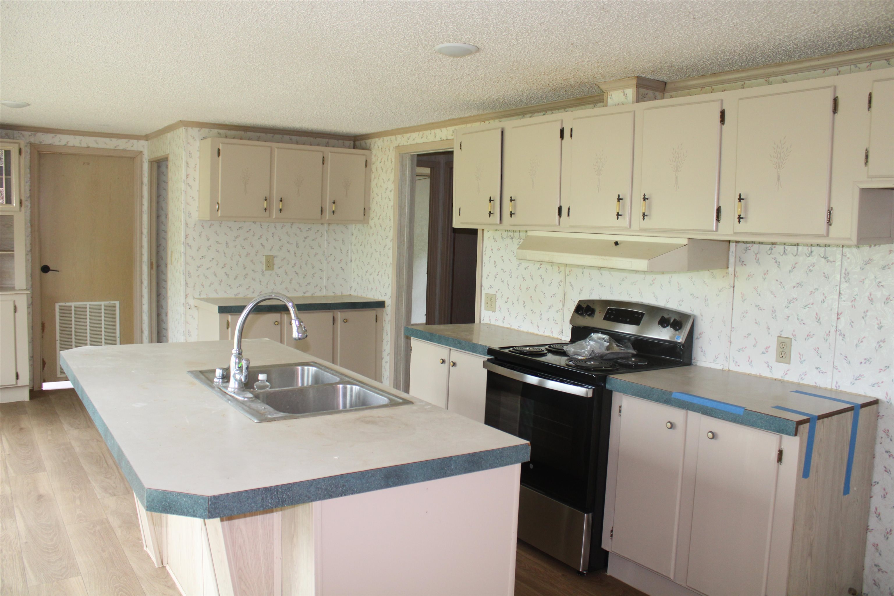 1660 Candy Owens Road Moscow, TN 38057 - Photo 8 of 14 a kitchen with a sink a stove and cabinets