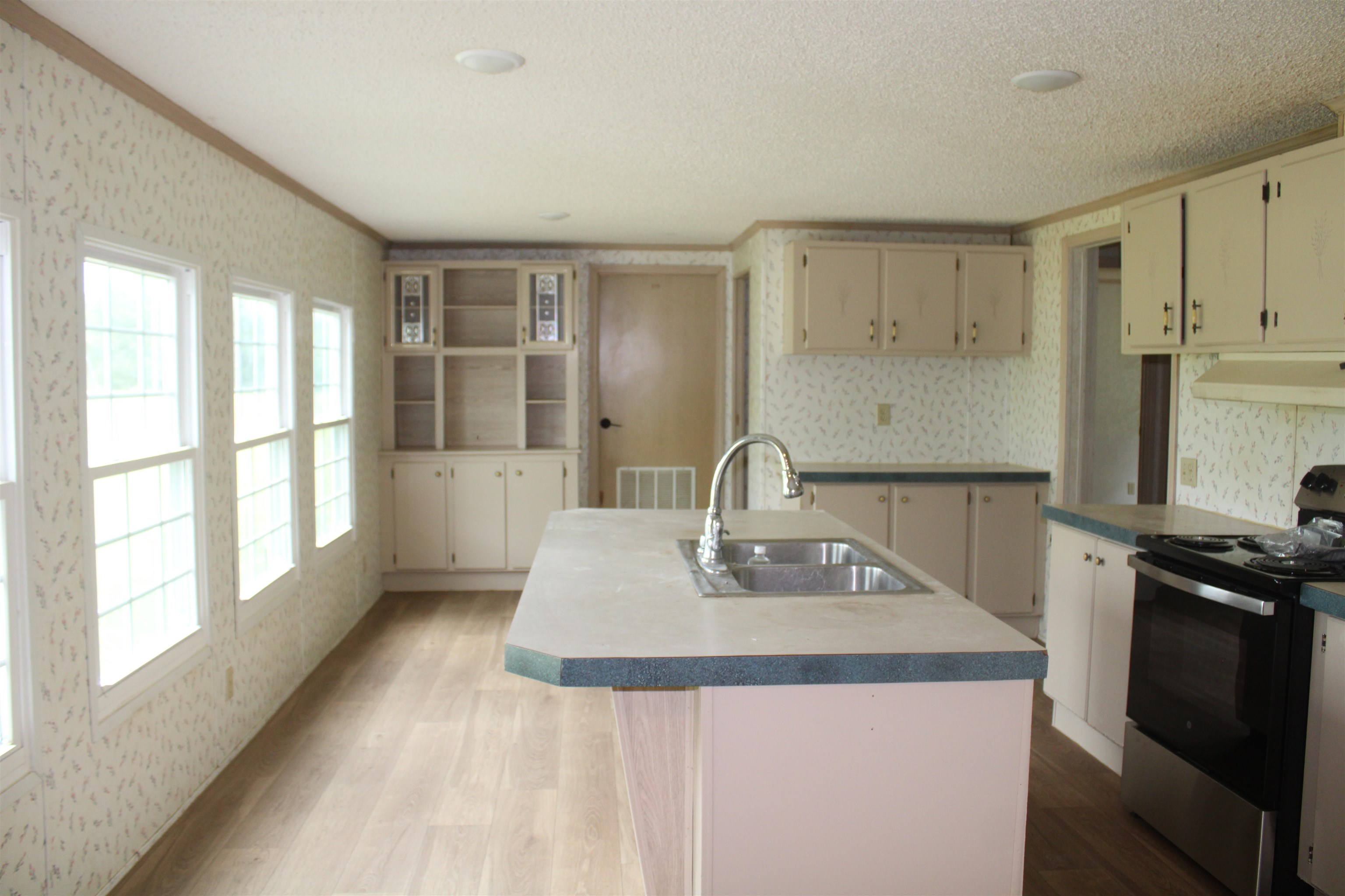 1660 Candy Owens Road Moscow, TN 38057 - Photo 9 of 14 a kitchen with a sink a stove and cabinets