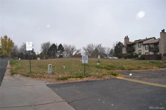 a view of a street with houses in the background