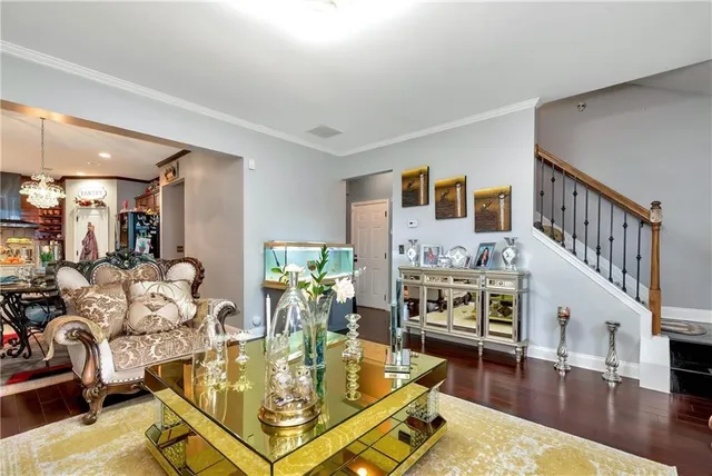 a living room with furniture flat screen tv and a table