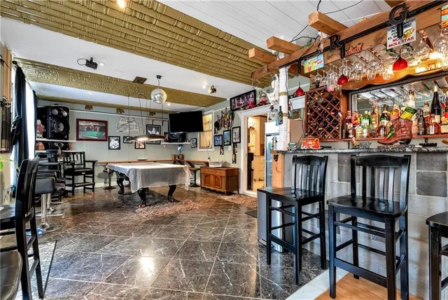 a very nice looking room with kitchen view