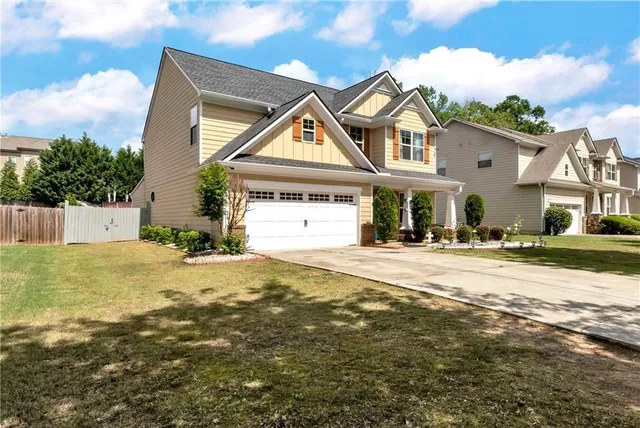 a front view of a house with a yard and garage