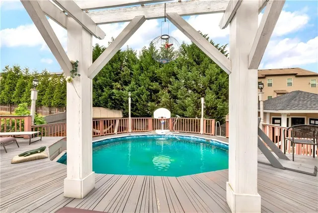 a view of a house with swimming pool and sitting area