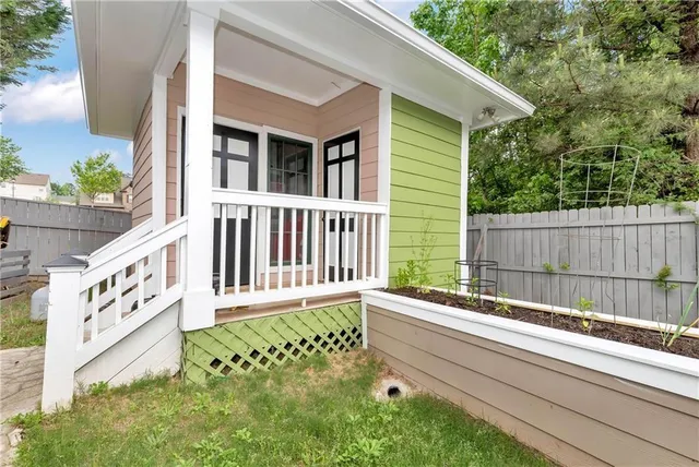 a view of a backyard with grass and a large tree