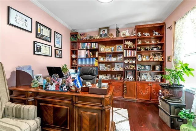 a living room with furniture cabinets and wooden floor