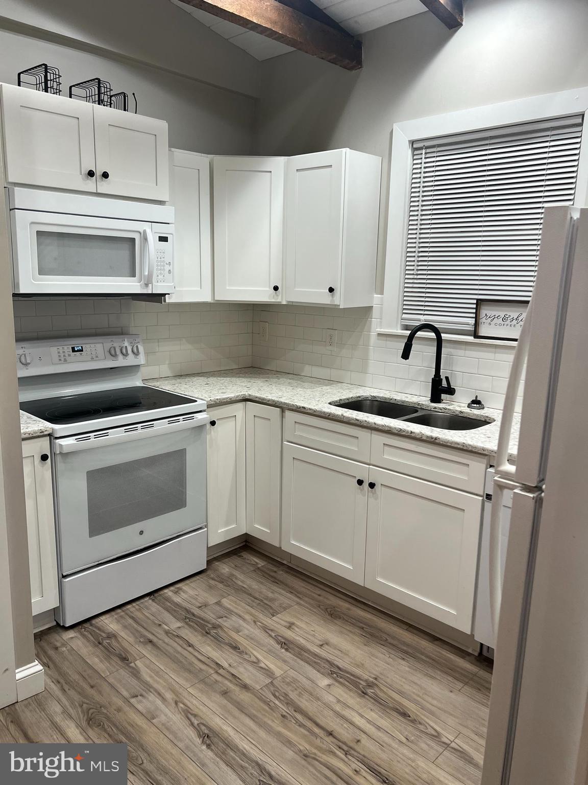 18 West Liberty Street Lancaster, PA 17603 - Photo 4 of 21 a kitchen with white cabinets appliances and sink