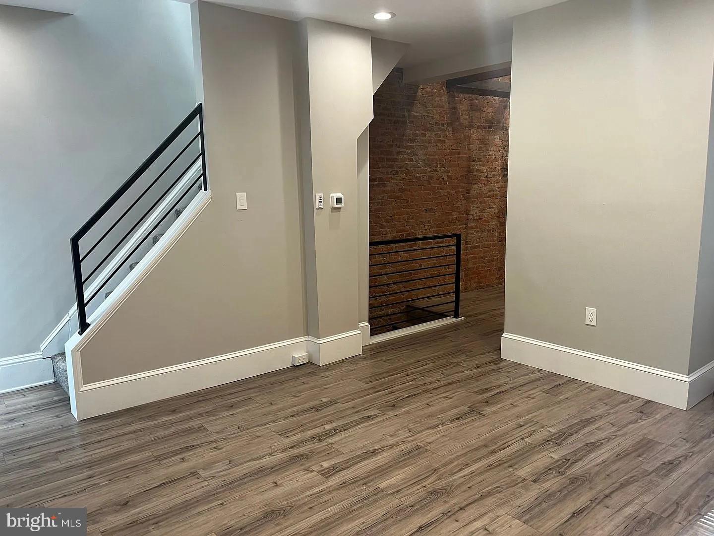 18 West Liberty Street Lancaster, PA 17603 - Photo 6 of 21 an empty room with wooden floor and entryway