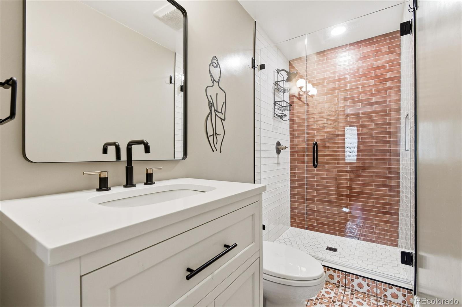 221 Oneida Street Denver, CO 80220 - Photo 12 of 24 a bathroom with a sink a toilet and shower