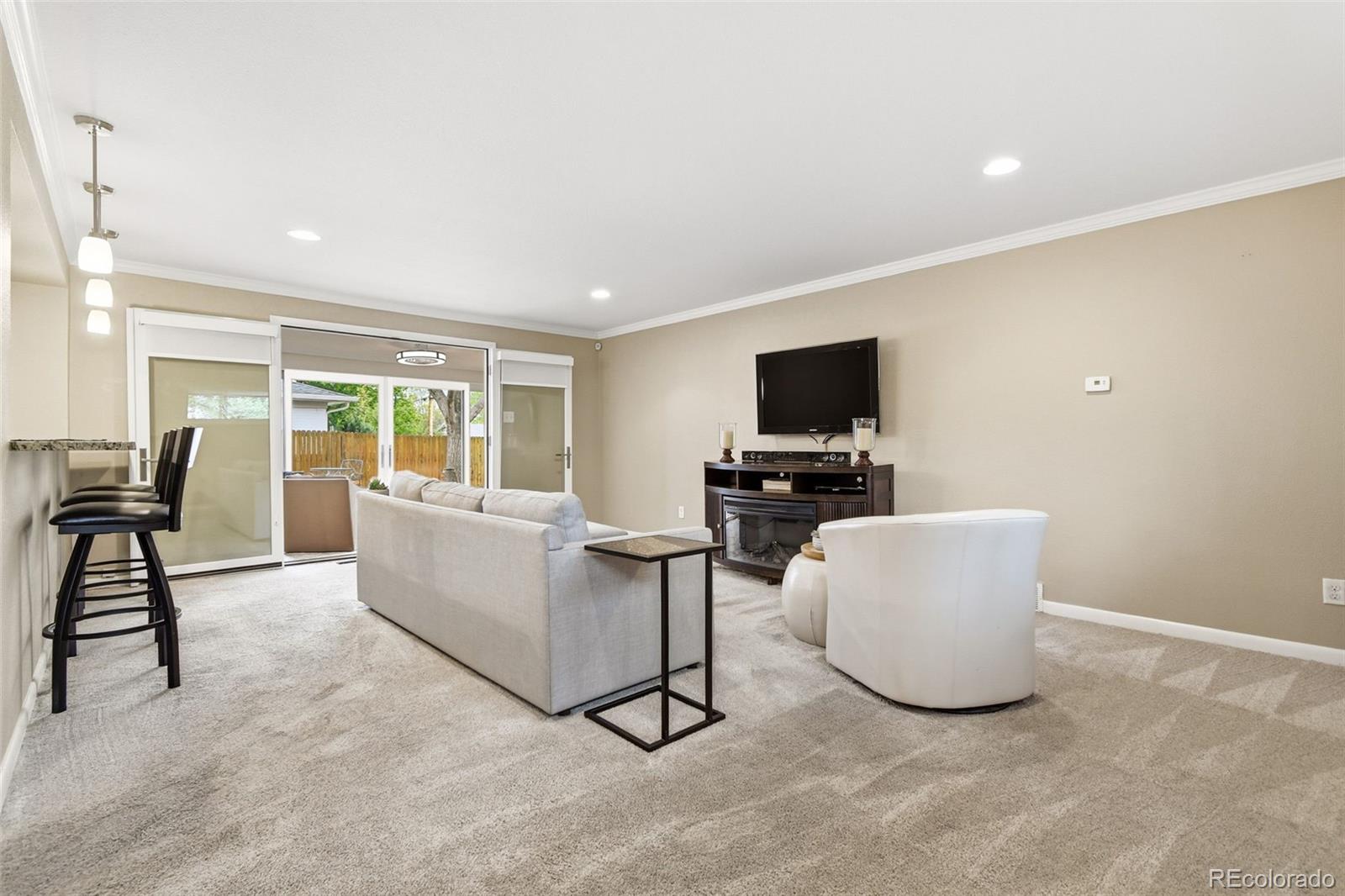 221 Oneida Street Denver, CO 80220 - Photo 17 of 24 a living room with furniture and a flat screen tv