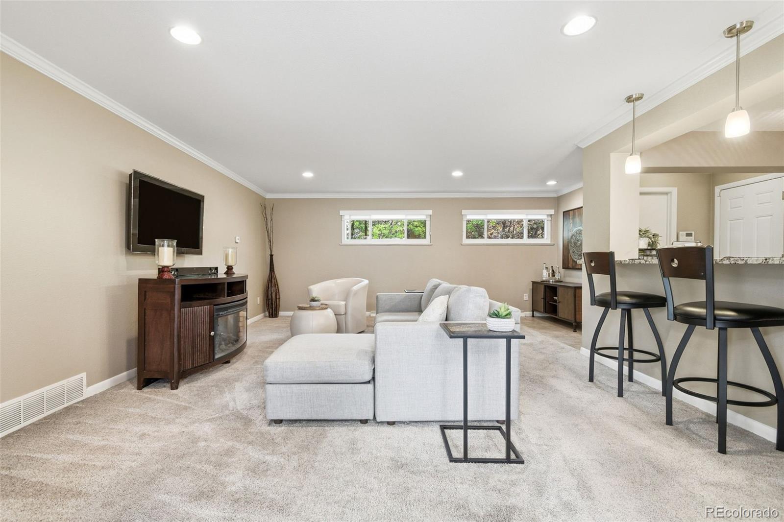 221 Oneida Street Denver, CO 80220 - Photo 20 of 24 a living room with furniture and a flat screen tv