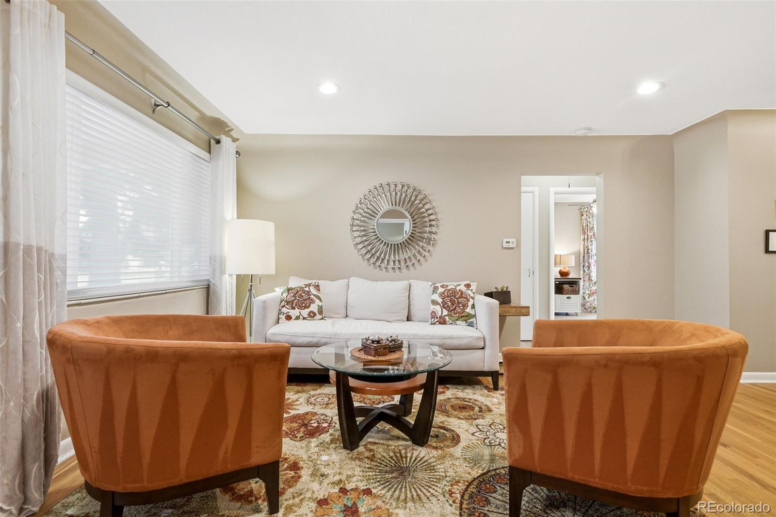 221 Oneida Street Denver, CO 80220 - Photo 2 of 24 a living room with furniture a large window and a table