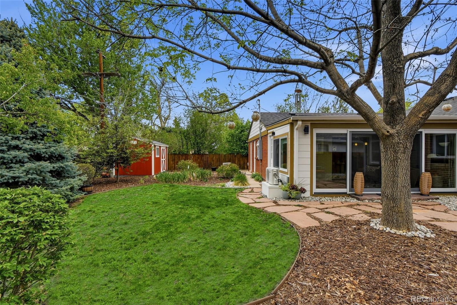 221 Oneida Street Denver, CO 80220 - Photo 24 of 24 a view of a chair and table in backyard of the house