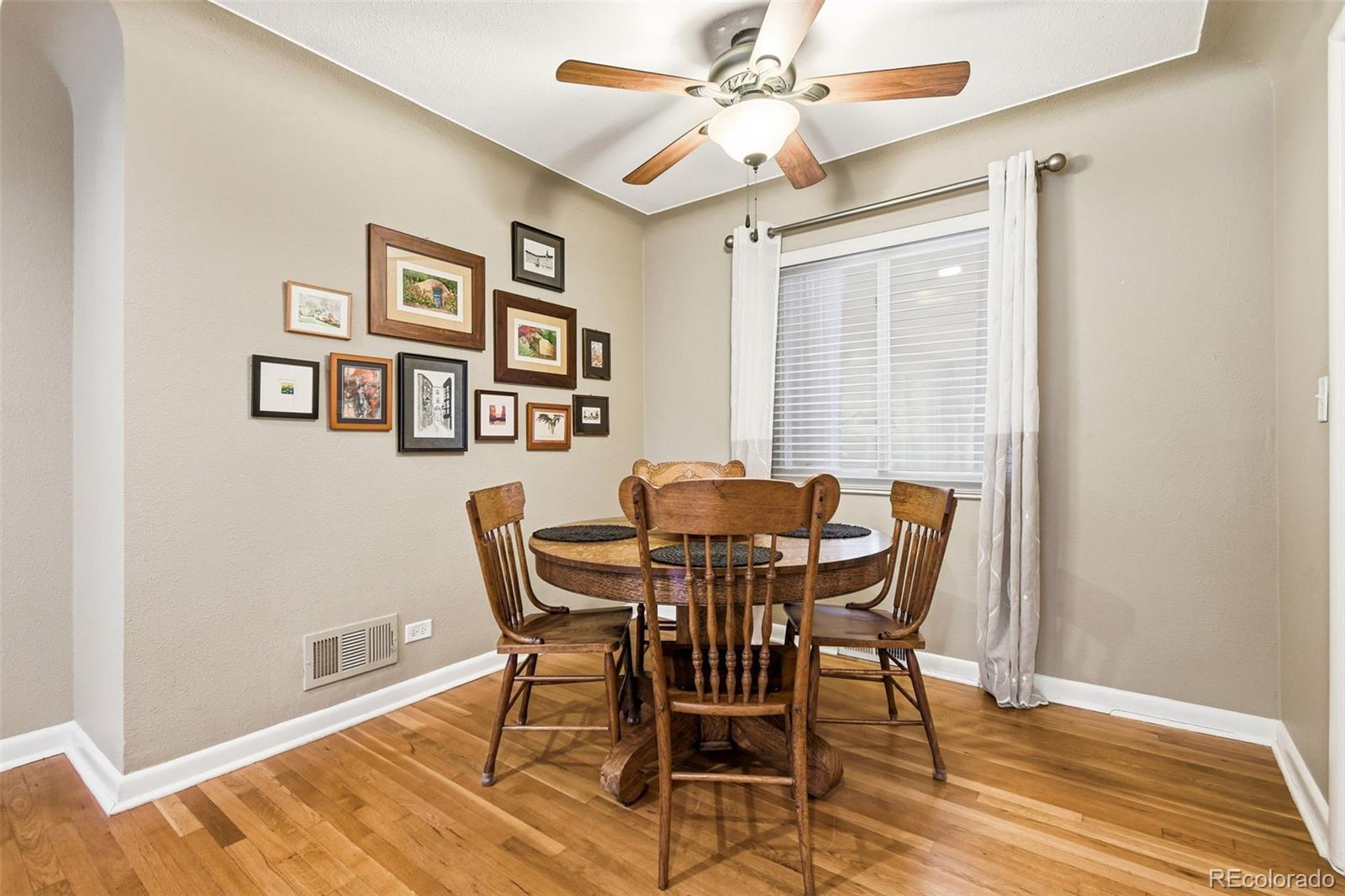 221 Oneida Street Denver, CO 80220 - Photo 5 of 24 a view of a dining room with furniture and wooden floor