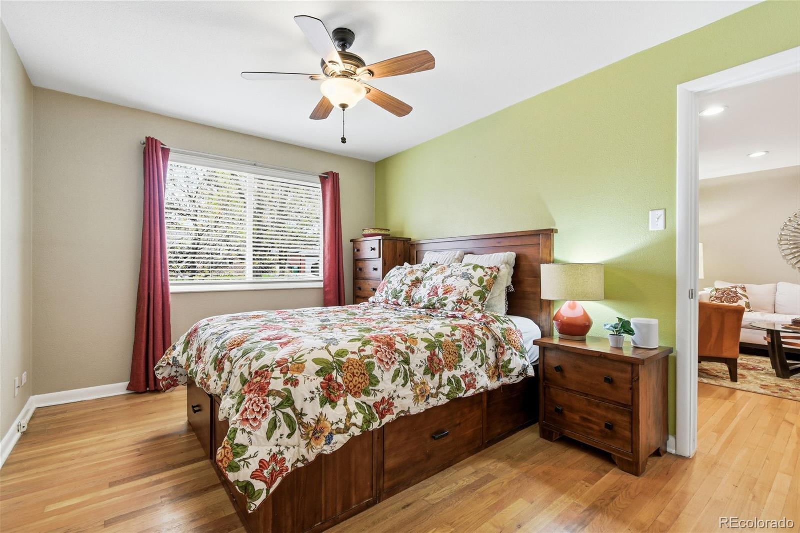 221 Oneida Street Denver, CO 80220 - Photo 10 of 24 a bedroom with a bed and a chandelier