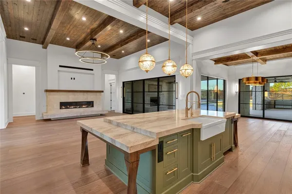 a large kitchen with a table and chairs