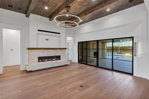 a view of an empty room with a fireplace and a window