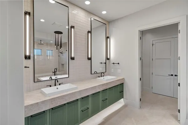 a bathroom with double vanity sinks and a mirror