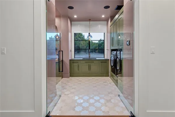 a view of a kitchen with a sink and a refrigerator