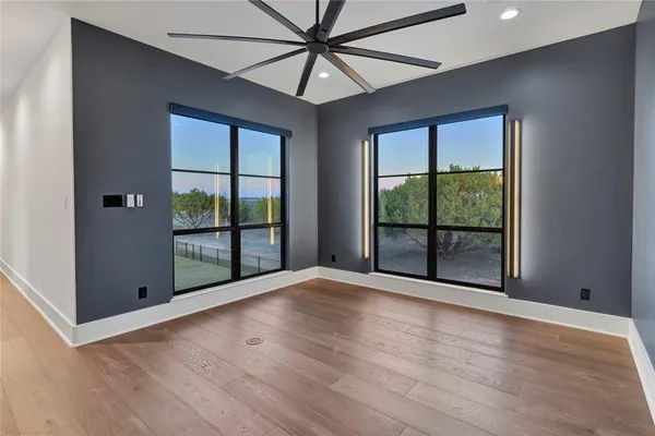 a view of room with window and wooden floor