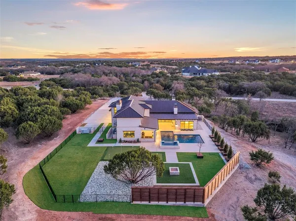 an aerial view of residential houses with outdoor space and river