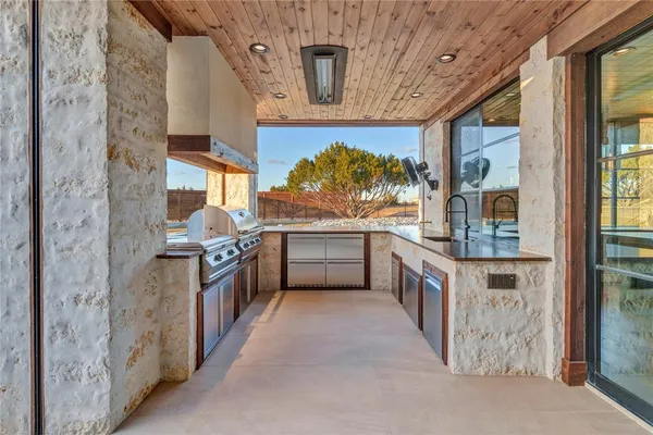 a kitchen with stainless steel appliances a stove and more cabinets