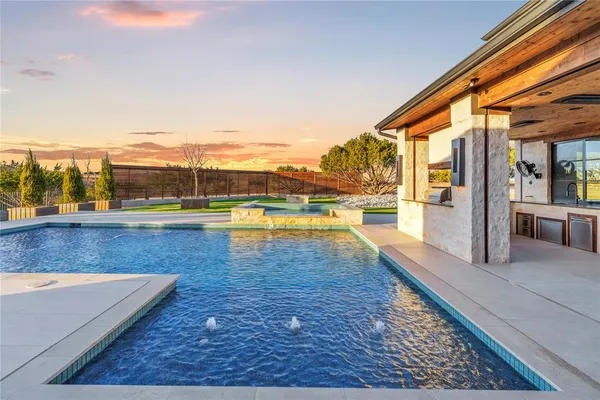 a view of swimming pool with outdoor seating and plants