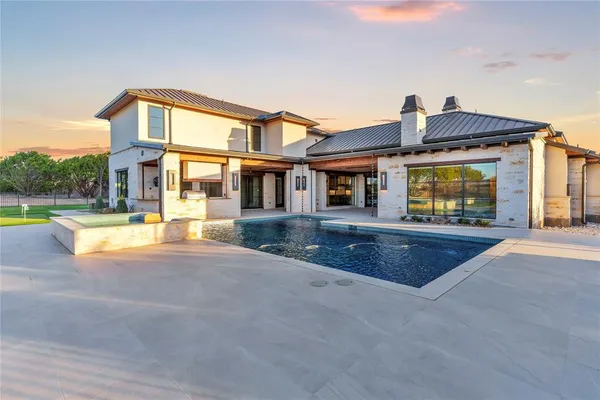 a view of a house with swimming pool and a yard