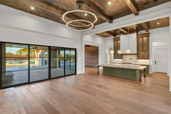 a view of an empty room with a fireplace and a large window