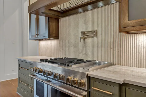 a stove top oven sitting inside of a kitchen