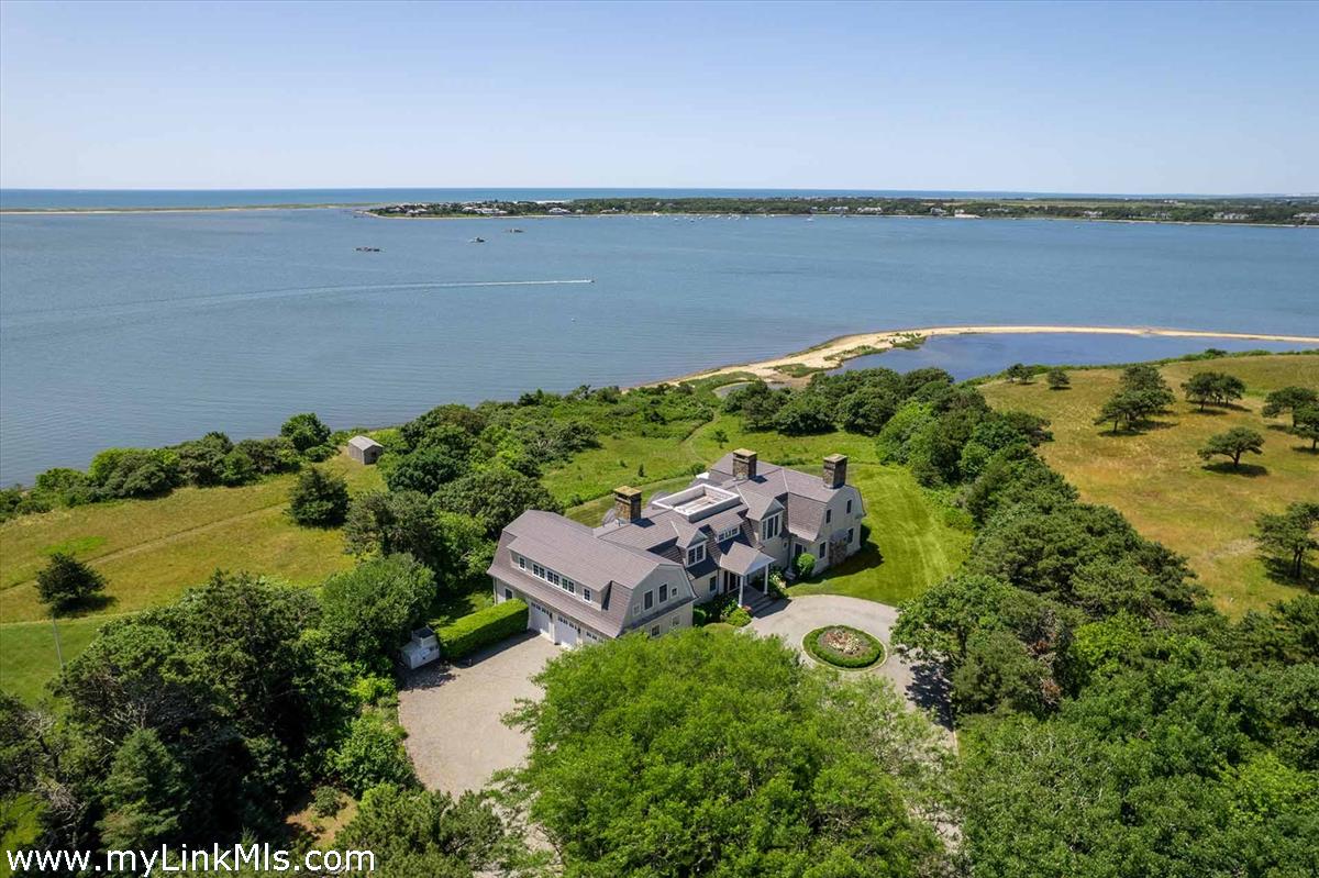 25 Lelands Path Edgartown, MA 02539 - Photo 4 of 56 an aerial view of ocean with residential house with outdoor space and trees in the background