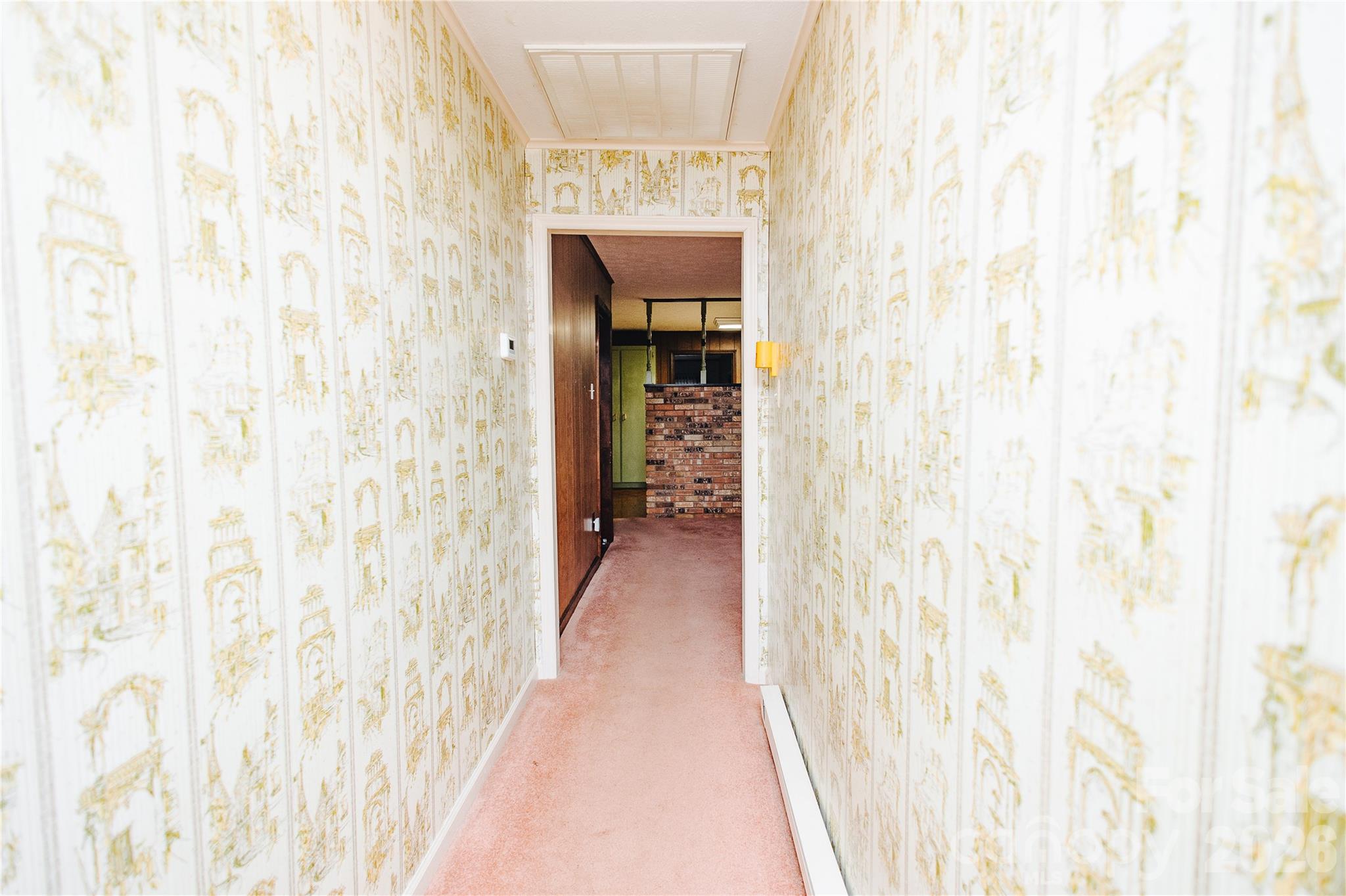205 Bond Street Marion, NC 28752 - Photo 18 of 37 a view of a hallway with wooden floor and a bathroom