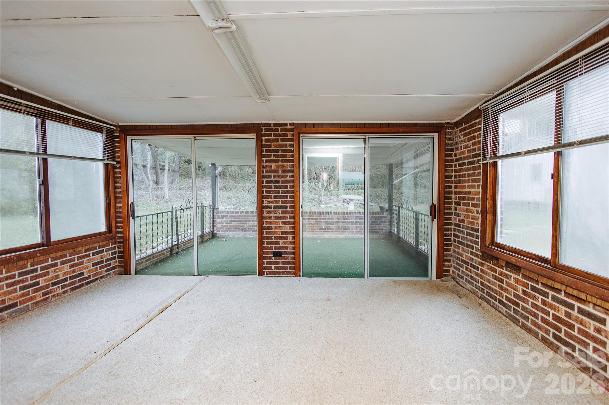 205 Bond Street Marion, NC 28752 - Photo 23 of 37 a view of an empty room with wooden floor and a window