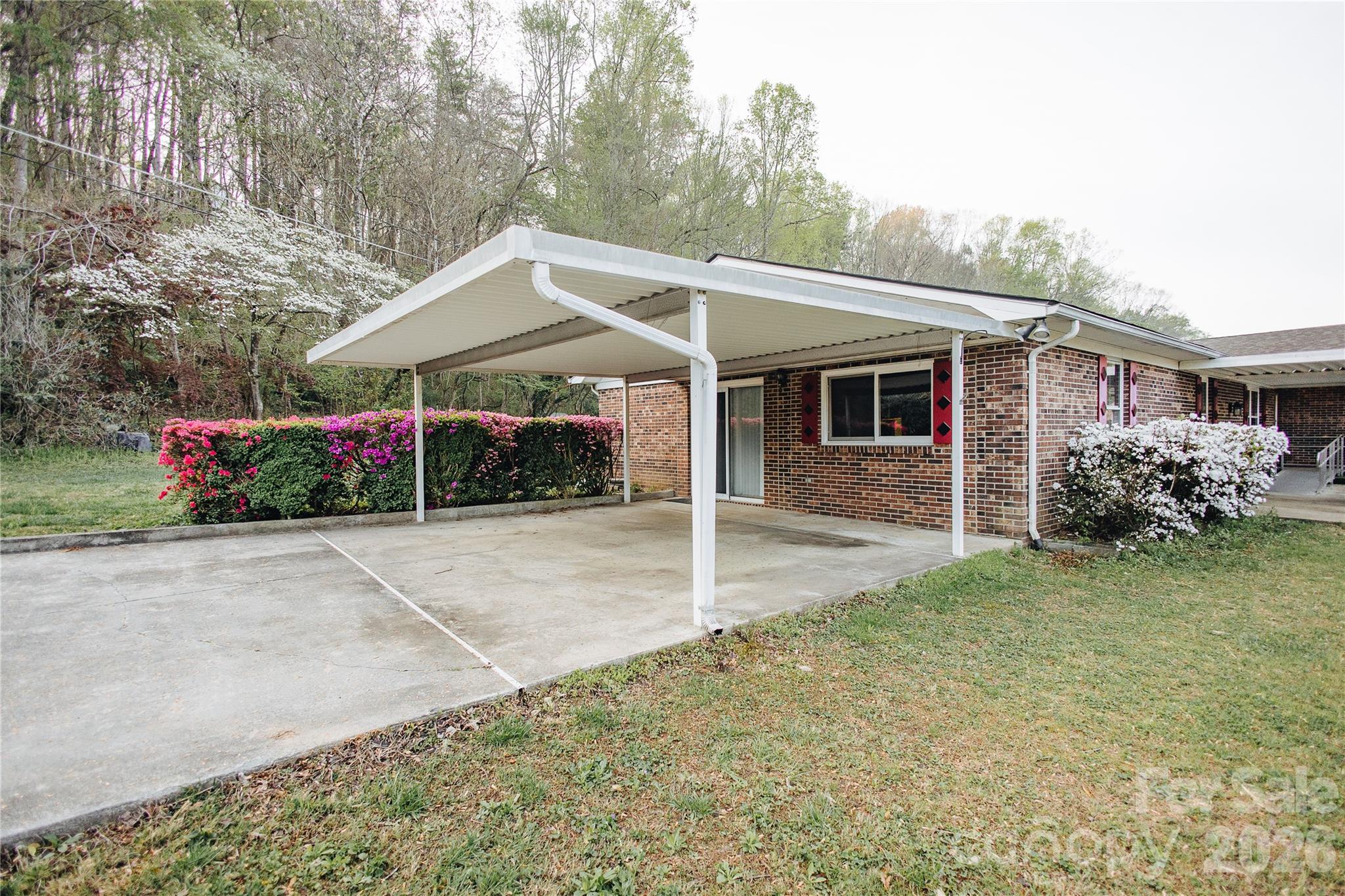 205 Bond Street Marion, NC 28752 - Photo 3 of 37 a view of a house with yard and a garden