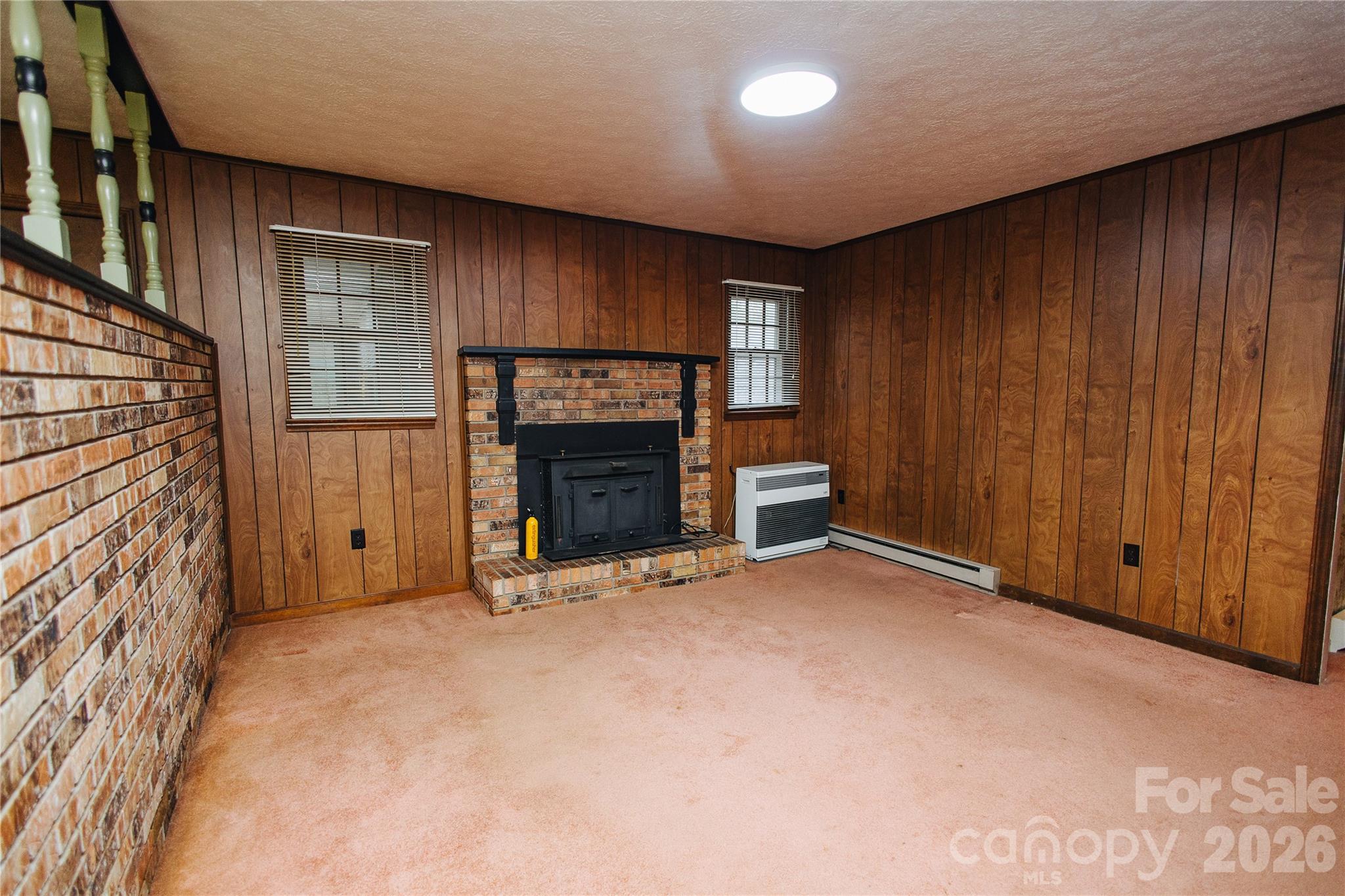 205 Bond Street Marion, NC 28752 - Photo 33 of 37 an empty room with fireplace and windows
