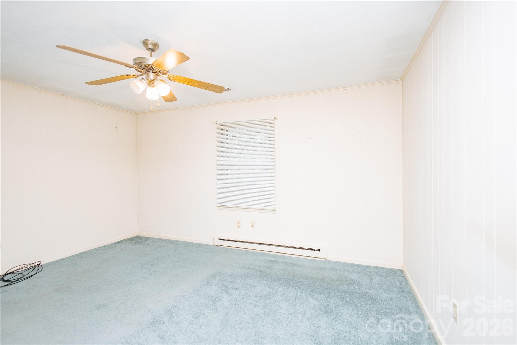 205 Bond Street Marion, NC 28752 - Photo 6 of 37 an empty room with a window and ceiling fan