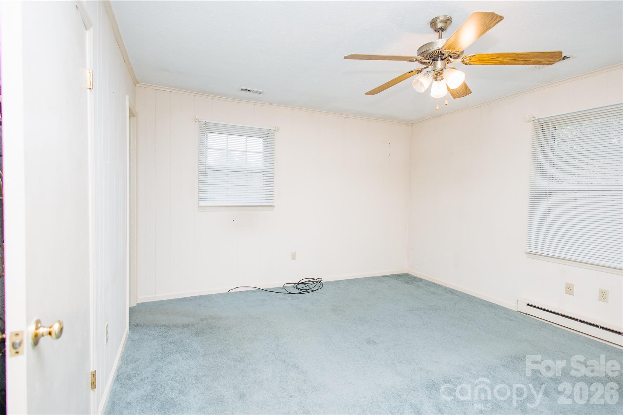 205 Bond Street Marion, NC 28752 - Photo 7 of 37 an empty room with a window and a ceiling fan