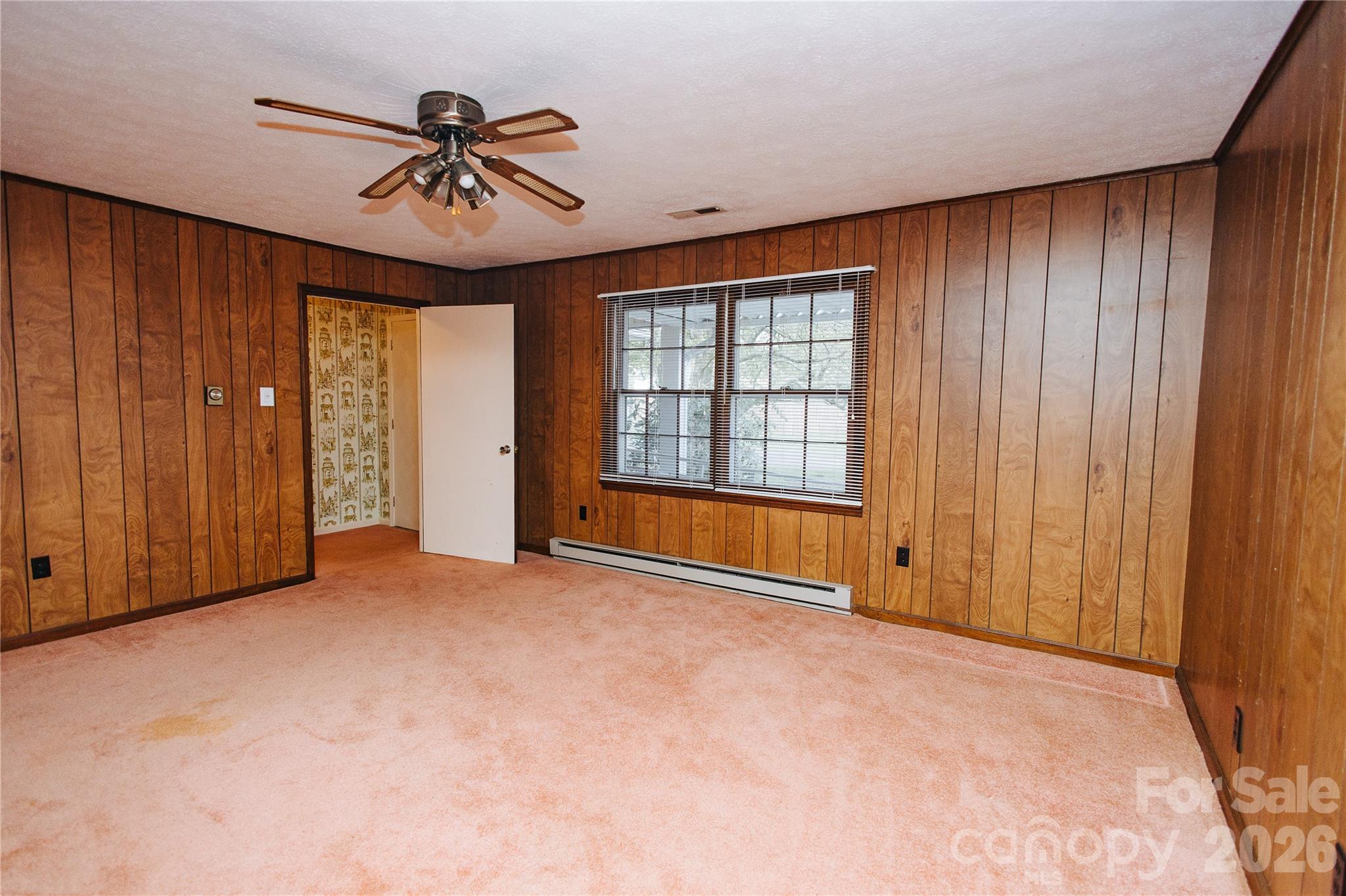205 Bond Street Marion, NC 28752 - Photo 10 of 37 an empty room with ceiling fan and windows