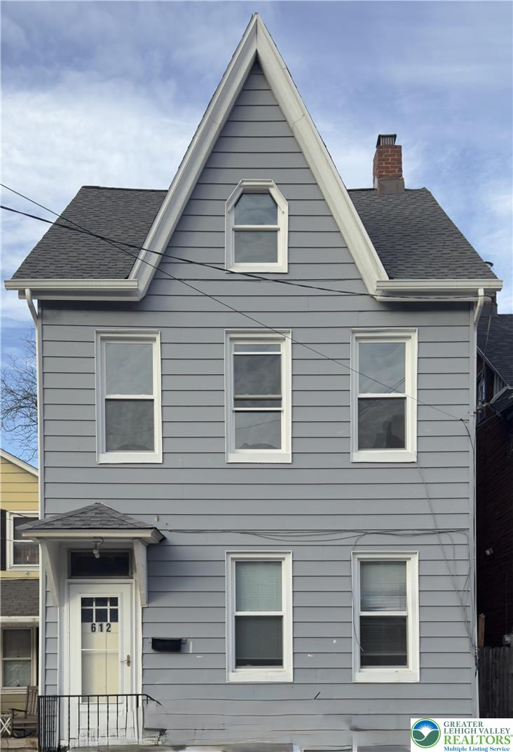 a front view of a house with many windows
