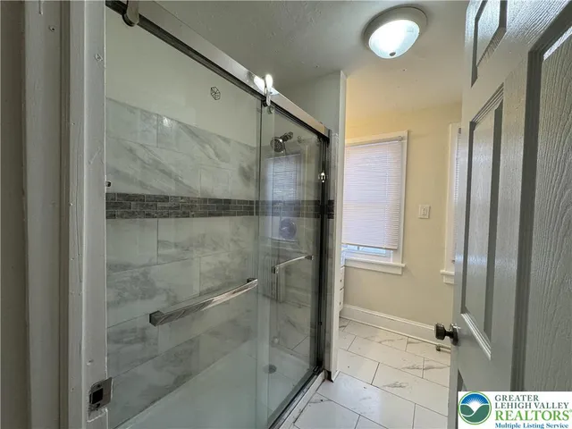 a bathroom with a glass shower door