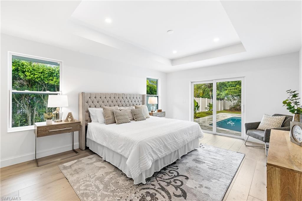2001 Alamanda Drive Naples, FL 34102 - Photo 11 of 32 a bedroom with a large bed and a window