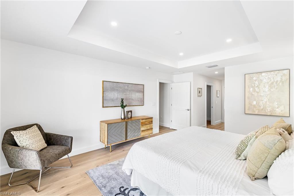 2001 Alamanda Drive Naples, FL 34102 - Photo 12 of 32 a bedroom with a bed and chair