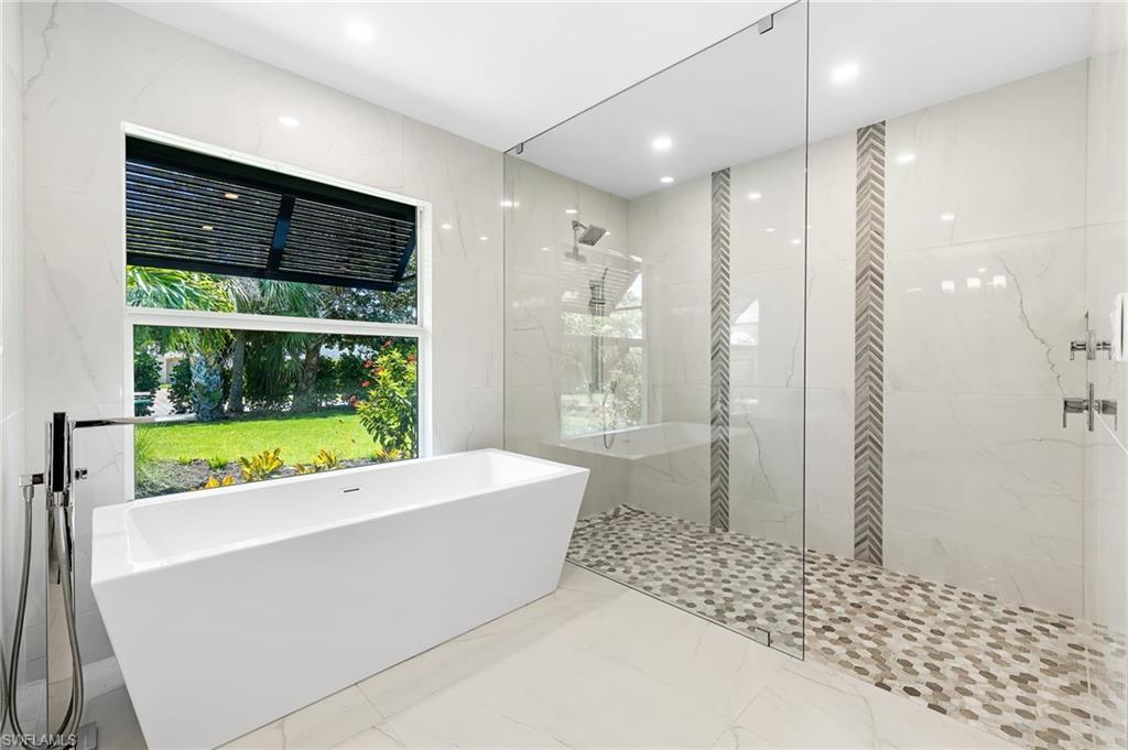 2001 Alamanda Drive Naples, FL 34102 - Photo 13 of 32 a bathroom with a bathtub and a shower