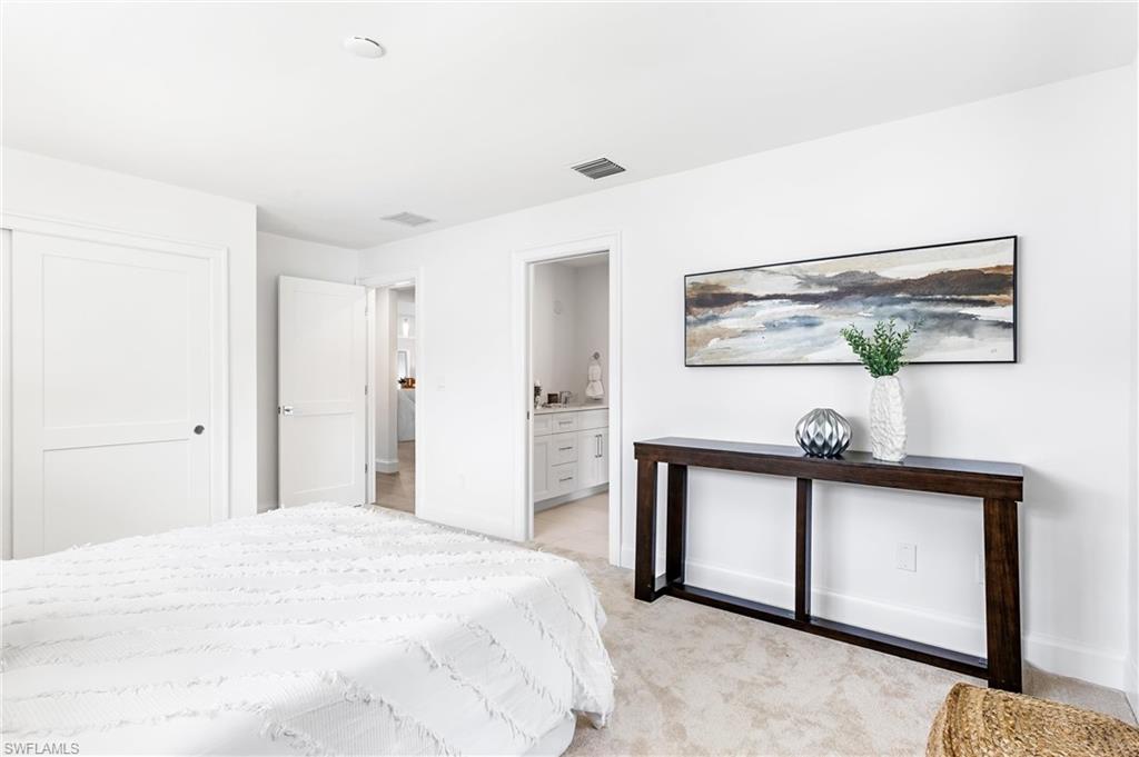 2001 Alamanda Drive Naples, FL 34102 - Photo 17 of 32 a bedroom with a bed and a dresser