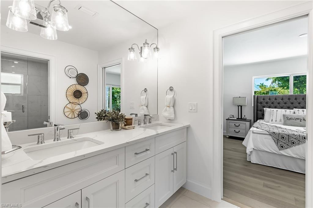 2001 Alamanda Drive Naples, FL 34102 - Photo 18 of 32 a en suite bathroom with double sink and a mirror