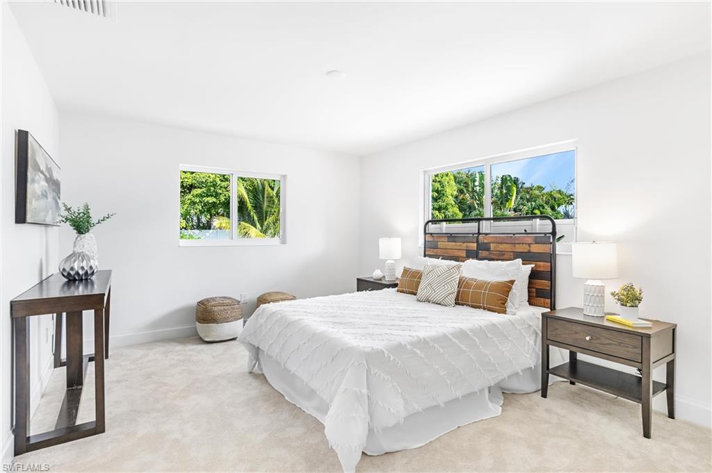 2001 Alamanda Drive Naples, FL 34102 - Photo 20 of 32 a bedroom with a bed a painting and a window