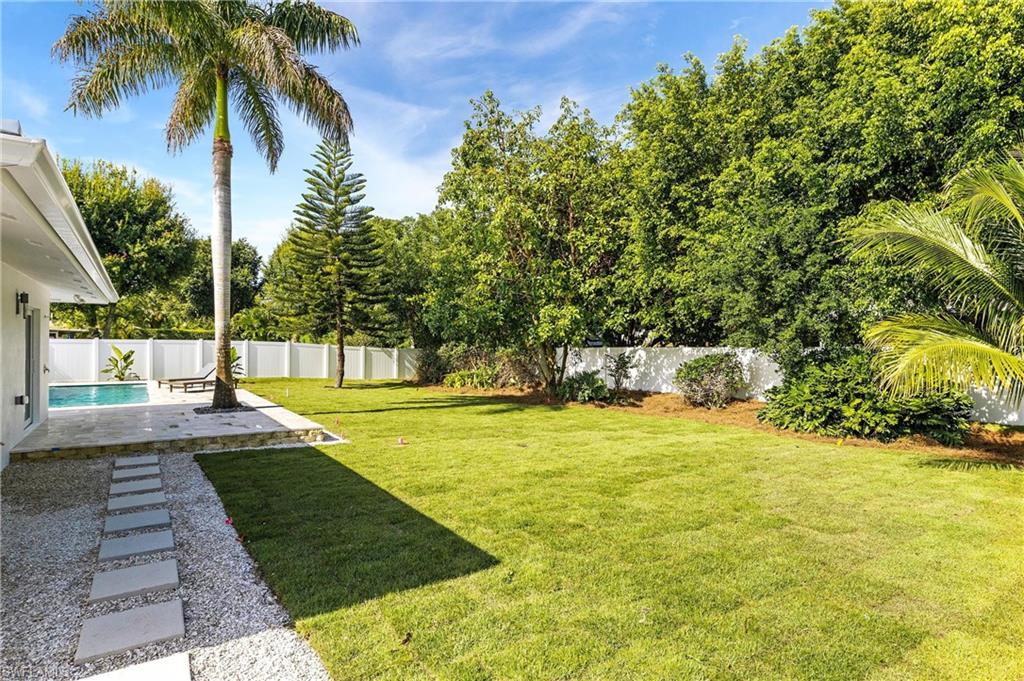 2001 Alamanda Drive Naples, FL 34102 - Photo 27 of 32 a view of a swimming pool with a garden