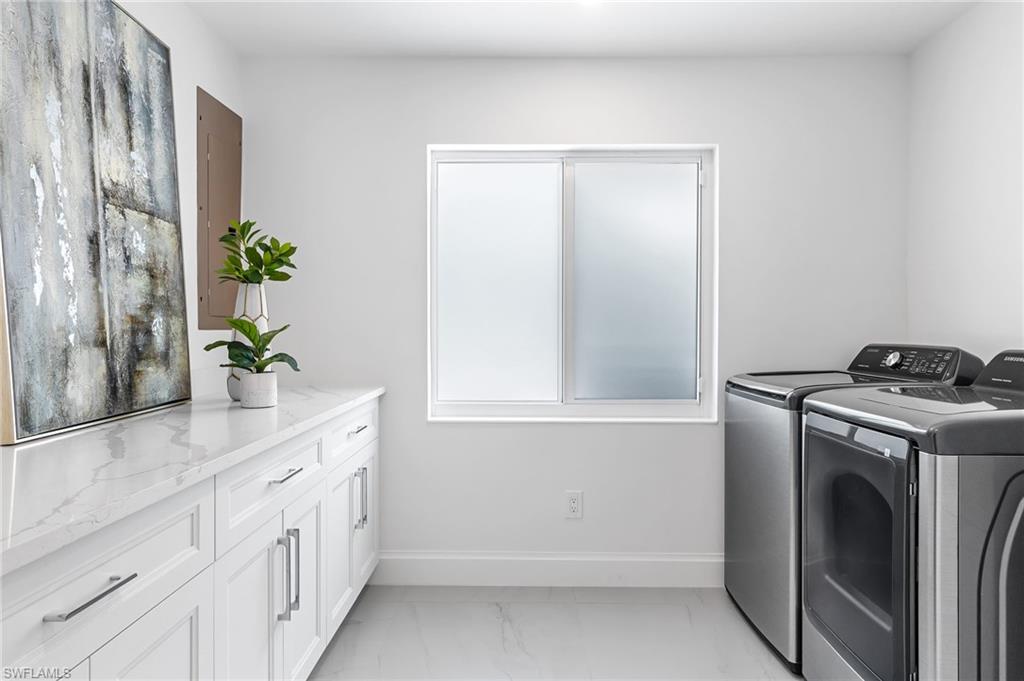 2001 Alamanda Drive Naples, FL 34102 - Photo 30 of 32 a bathroom with a sink and a mirror