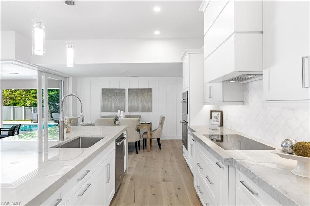2001 Alamanda Drive Naples, FL 34102 - Photo 6 of 32 a kitchen with granite countertop a sink a counter space appliances and cabinets