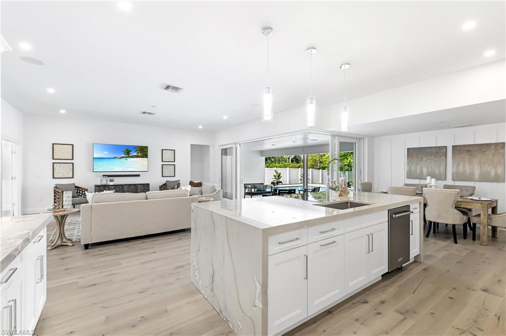 2001 Alamanda Drive Naples, FL 34102 - Photo 7 of 32 a large kitchen with a large window and white cabinets