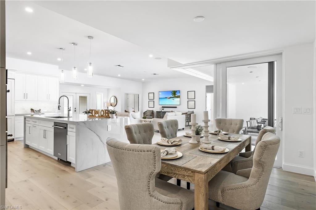 2001 Alamanda Drive Naples, FL 34102 - Photo 8 of 32 a view of a dining room with furniture and wooden floor